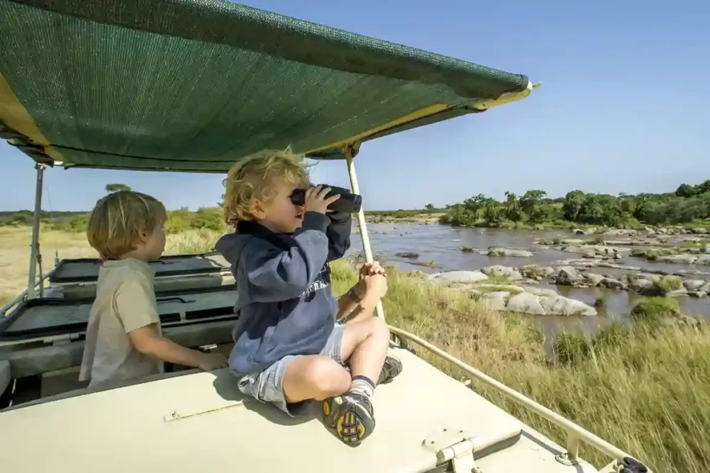 Happy children with binoculars: serengeti family safari adventure